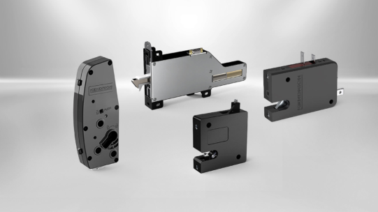 Vier verschiedene, moderne Elektromagnete auf grauem Hintergrund, darunter ein Drehmagnet und ein Linearaktor.